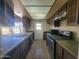 Galley kitchen with ample counter space, and a stainless steel oven at 15602 N 55Th Ave, Glendale, AZ 85306