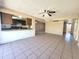 Open-concept living room with tile floors open to kitchen at 15602 N 55Th Ave, Glendale, AZ 85306