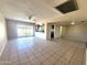 Open-concept living room with tile floors and sliding glass doors to backyard at 15602 N 55Th Ave, Glendale, AZ 85306