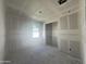 Bedroom under construction with drywall and one window, featuring recessed lighting and smooth concrete flooring at 16174 W Bajada Rd, Surprise, AZ 85387