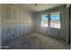 Bedroom under construction with drywall, featuring two windows offering natural light, and smooth concrete flooring at 16174 W Bajada Rd, Surprise, AZ 85387