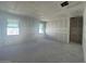 Bright bedroom under construction with drywall, featuring two windows offering natural light, and smooth concrete flooring at 16174 W Bajada Rd, Surprise, AZ 85387