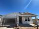 New home construction featuring a covered entryway and a two-car garage under a clear, blue sky at 16174 W Bajada Rd, Surprise, AZ 85387