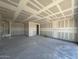 Spacious unfinished garage showcasing ample room and potential for customization with drywall at 16174 W Bajada Rd, Surprise, AZ 85387