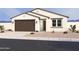 Charming single-story home featuring a two-car garage and desert landscaping at 16190 W Bajada Rd, Surprise, AZ 85387