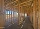 Interior view of new home construction showing wood framing and future room layouts at 16190 W Bajada Rd, Surprise, AZ 85387