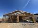 New construction showing wood framing and open layout against a bright blue sky at 16190 W Bajada Rd, Surprise, AZ 85387