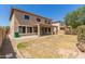 Expansive backyard showcasing a covered patio area, promising a versatile space for relaxation, gatherings, and enjoying the outdoors at 17419 W Elaine Dr, Goodyear, AZ 85338