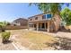 Spacious backyard featuring a covered patio, gravel area, and potential for landscaping, perfect for outdoor entertaining at 17419 W Elaine Dr, Goodyear, AZ 85338