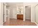 Bathroom with a tiled floor, wooden vanity and framed mirror at 17419 W Elaine Dr, Goodyear, AZ 85338