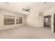 Bright bedroom with plush carpeting, ceiling fan and natural light from the windows at 17419 W Elaine Dr, Goodyear, AZ 85338