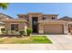 Charming two-story home featuring a well-manicured lawn and a two-car garage at 17419 W Elaine Dr, Goodyear, AZ 85338