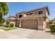 Charming two-story home featuring a well-manicured lawn and a two-car garage at 17419 W Elaine Dr, Goodyear, AZ 85338
