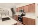 Modern kitchen with stainless steel appliances, Quartz countertops, and wood cabinets at 17419 W Elaine Dr, Goodyear, AZ 85338