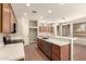 The kitchen has stainless steel appliances, wood cabinets, and seamless transition to dining area at 17419 W Elaine Dr, Goodyear, AZ 85338