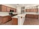 Modern kitchen features countertops, wood cabinets, updated appliances, and functional layout at 17419 W Elaine Dr, Goodyear, AZ 85338