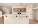 Modern kitchen with stainless steel appliances, wood cabinets, and an adjacent dining area at 17419 W Elaine Dr, Goodyear, AZ 85338