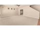 Spacious living room featuring neutral carpet, ceiling fan, and open layout at 17419 W Elaine Dr, Goodyear, AZ 85338