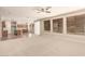Bright and airy living room featuring neutral carpet, large windows, and an open layout to the kitchen at 17419 W Elaine Dr, Goodyear, AZ 85338