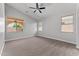 Bedroom featuring neutral carpet, vaulted ceiling, and dual windows providing natural light at 18119 W Spencer Dr, Surprise, AZ 85374