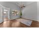 Bright bedroom featuring hardwood floors, a ceiling fan, and a large window with backyard views at 18119 W Spencer Dr, Surprise, AZ 85374