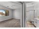 Bedroom showcasing a window and a doorway leading to the ensuite bathroom at 18119 W Spencer Dr, Surprise, AZ 85374