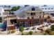 Aerial view of clubhouse with large windows, outdoor seating, and landscaping at 18119 W Spencer Dr, Surprise, AZ 85374