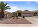 Well-maintained single-story home features a desert landscape and a two-car garage at 18119 W Spencer Dr, Surprise, AZ 85374