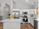 Modern kitchen design features stainless steel appliances and a center marble island at 18119 W Spencer Dr, Surprise, AZ 85374