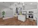 Elegant kitchen with stainless steel appliances, marble island, and open floor plan at 18119 W Spencer Dr, Surprise, AZ 85374