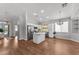 Bright kitchen boasts white cabinets, stainless appliances, island, and recessed lighting at 18119 W Spencer Dr, Surprise, AZ 85374