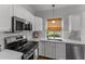 Charming kitchen with white cabinets, stainless appliances, and marble countertops at 18119 W Spencer Dr, Surprise, AZ 85374