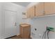 Laundry room with upper and lower cabinets, shelving and tile flooring at 18119 W Spencer Dr, Surprise, AZ 85374