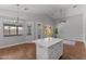 Open-concept living area featuring vaulted ceilings, hardwood floors, and large windows at 18119 W Spencer Dr, Surprise, AZ 85374