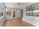 Bright sun room featuring tile floors, a ceiling fan, windows, and a bench seat at 18119 W Spencer Dr, Surprise, AZ 85374