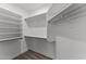 Walk-in closet with built in shelving and carpeted floor at 18119 W Spencer Dr, Surprise, AZ 85374
