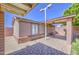 View of the tiled back patio area, featuring brick trim and desert landscaping at 1911 N 42Nd Ave, Phoenix, AZ 85009