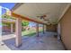 Covered back patio with ceiling fans and a view of the backyard with mature shade tree at 1911 N 42Nd Ave, Phoenix, AZ 85009