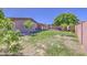Large backyard with grass, mature trees, a covered patio, and a block wall fence at 1911 N 42Nd Ave, Phoenix, AZ 85009