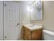 Functional bathroom with a wood vanity, framed mirror, and a standard toilet at 1911 N 42Nd Ave, Phoenix, AZ 85009
