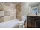 Nicely tiled bathroom features tiled shower/tub, vanity with dark wood finish at 1911 N 42Nd Ave, Phoenix, AZ 85009