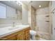 Bathroom featuring a tiled shower with built-in shelves and a wood vanity at 1911 N 42Nd Ave, Phoenix, AZ 85009