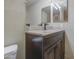 Bathroom vanity featuring a marble countertop, dark wood finish and decorative hardware at 1911 N 42Nd Ave, Phoenix, AZ 85009