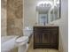Bathroom with tiled wall and floors, updated vanity with dark wood finish and tub at 1911 N 42Nd Ave, Phoenix, AZ 85009