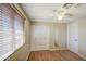Bedroom featuring wood-look floors, a window with blinds, ceiling fan, and closet at 1911 N 42Nd Ave, Phoenix, AZ 85009