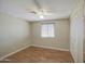 Cozy bedroom featuring wood-look flooring, a ceiling fan, and closet with mirrored door at 1911 N 42Nd Ave, Phoenix, AZ 85009