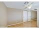 Bedroom featuring wood floors, a mirrored closet, and a ceiling fan at 1911 N 42Nd Ave, Phoenix, AZ 85009