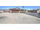 Single-story home with a brown tile roof, desert landscaping, and a long concrete driveway at 1911 N 42Nd Ave, Phoenix, AZ 85009