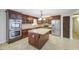 This kitchen features stainless steel appliances, granite countertops, a central island, and rich wood cabinetry at 1911 N 42Nd Ave, Phoenix, AZ 85009
