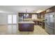 Traditional kitchen with granite counters, stainless steel appliances, central island, and tile flooring at 1911 N 42Nd Ave, Phoenix, AZ 85009